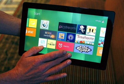 A Reuters reporter runs through a new test Microsoft Windows tablet running a version of its touch-enabled Windows 8, expected to be released in 2012, at the Build conference in Anaheim