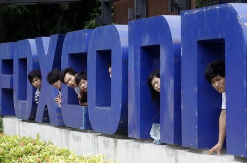 File photograph of Foxconn workers near the gate of a Foxconn factory in the township of Longhua